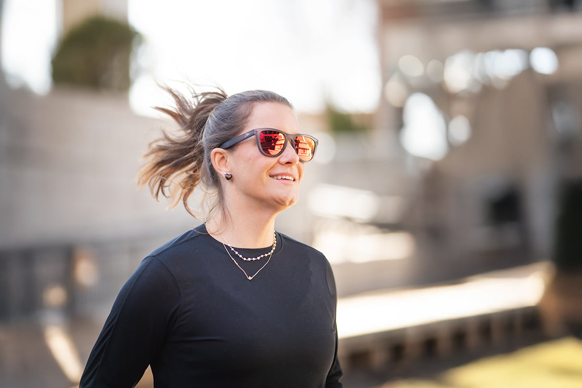 Snowboarder carving through powder in snowy terrain.