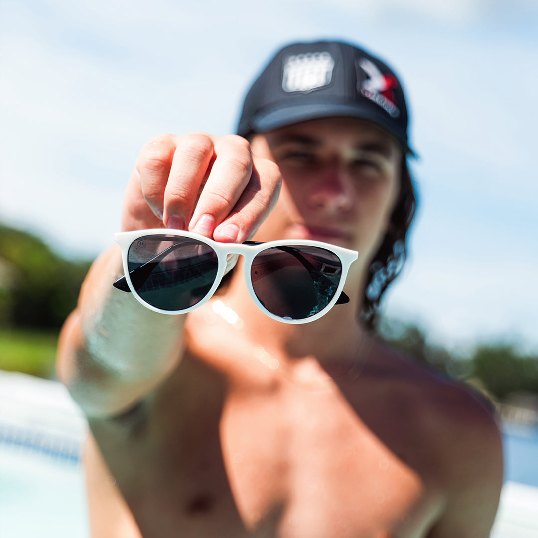 Snowboarder carving through powder in snowy terrain.