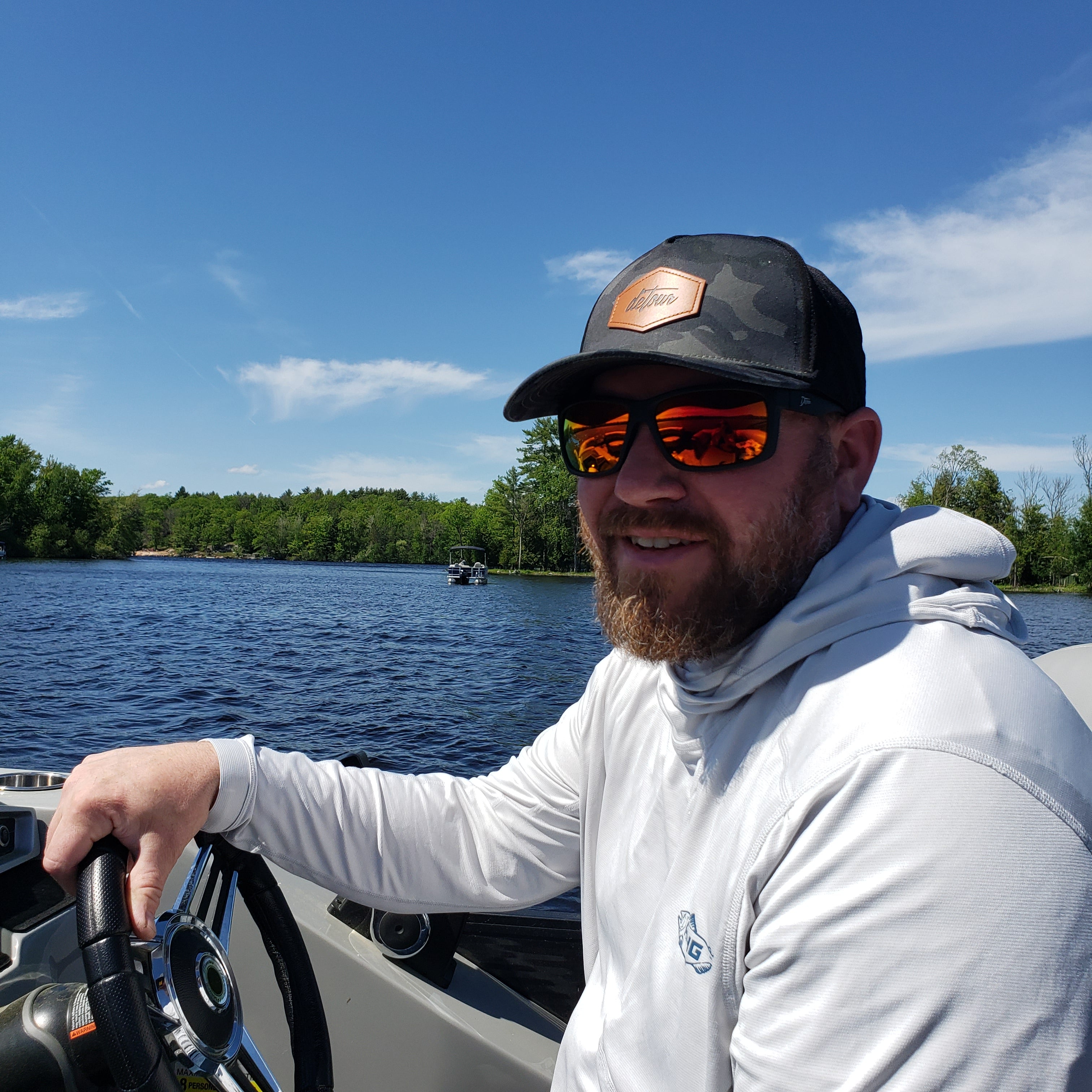 Snowboarder carving through powder in snowy terrain.