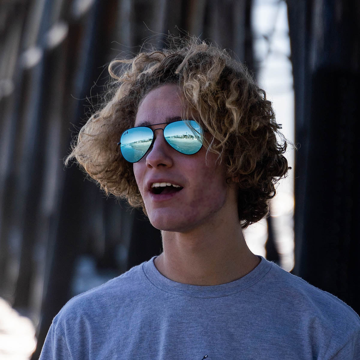Snowboarder carving through powder in snowy terrain.