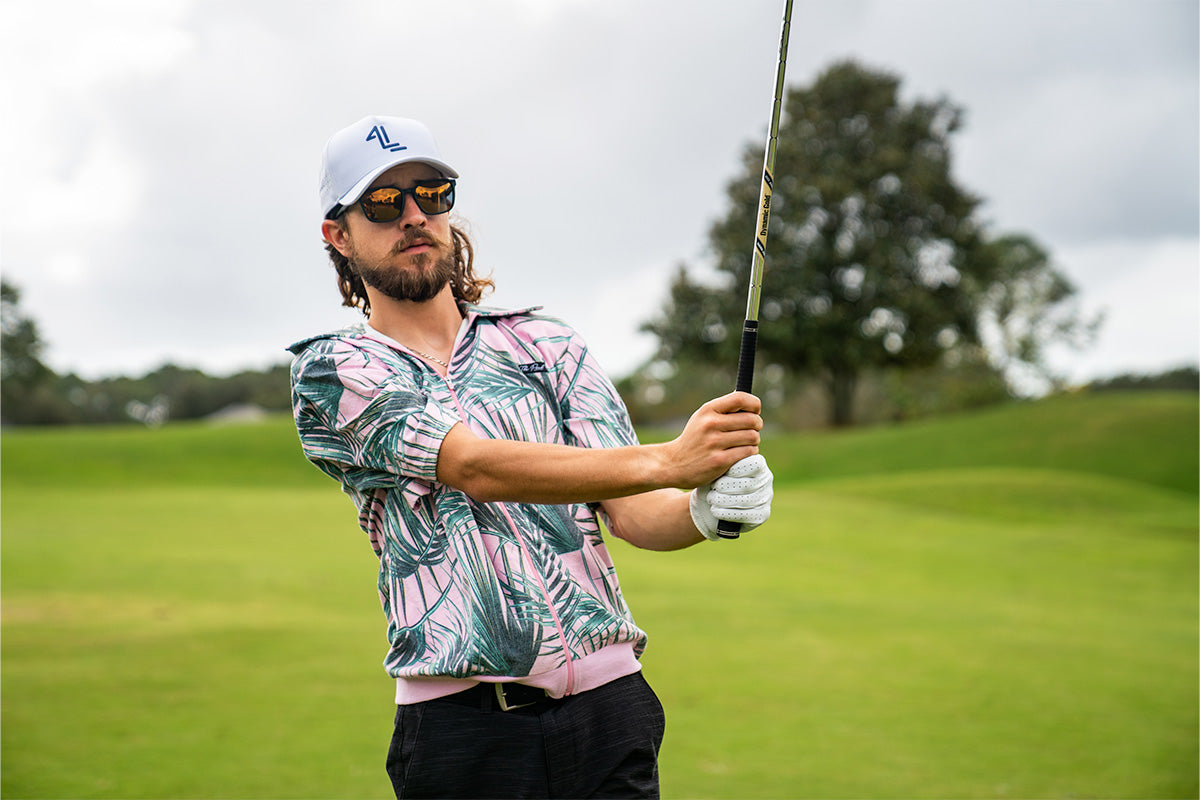Snowboarder carving through powder in snowy terrain.