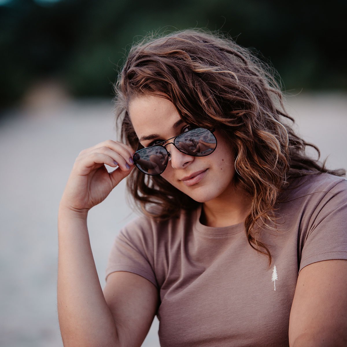 Snowboarder carving through powder in snowy terrain.